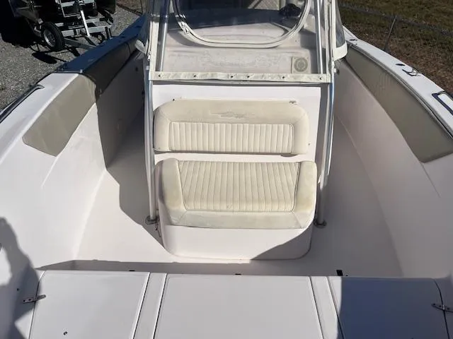 Slide: The Image of 2003 Grady-White 306 CC boat interior with cushioned seating and windshield. - 12
