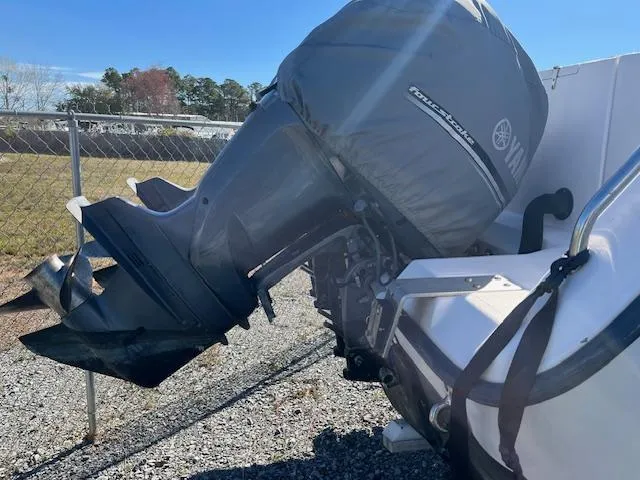 Slide: The Image of Outboard motor on a 2003 Grady-White 306 CC boat, parked on gravel. - 3