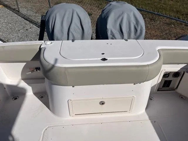 Slide: The Image of 2003 Grady-White 306 CC boat interior with covered engines and storage compartment. - 4