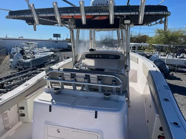 Slide: The Image of 2003 Grady-White 306 CC boat with center console and T-top in a marina setting. - 5