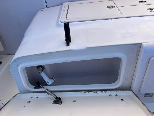 Slide: The Image of 2003 Grady-White 306 CC boat storage compartment with open hatch and visible hardware. - 6