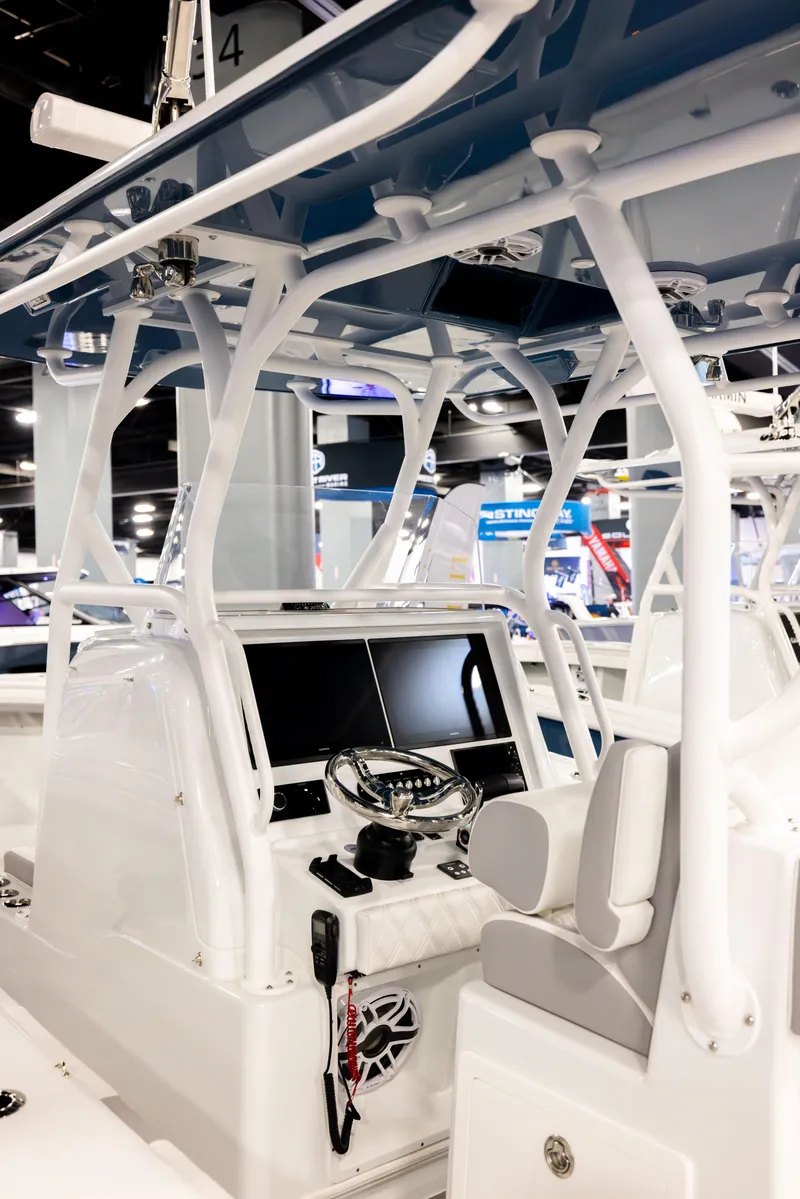 Slide: The Image of 2025 Yellowfin 32 Offshore boat interior with modern helm and seating. - 10