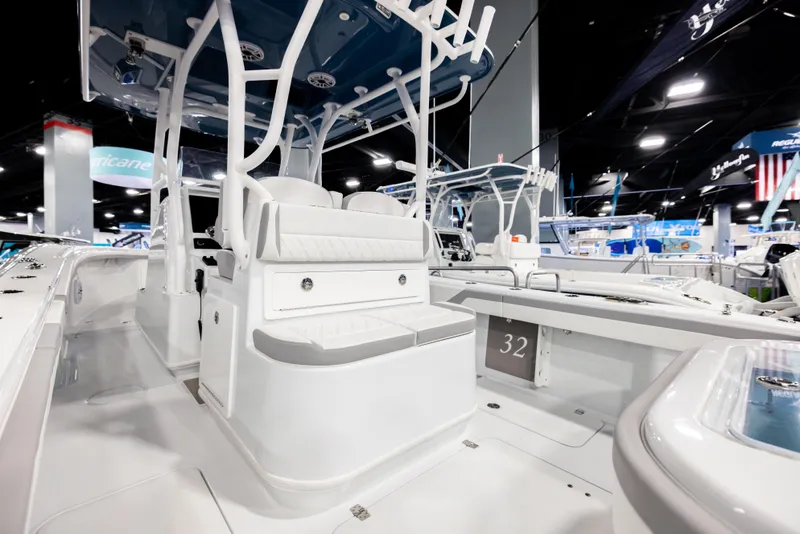 Slide: The Image of 2025 Yellowfin 32 Offshore boat interior at a boat show, featuring sleek seating and modern design. - 11