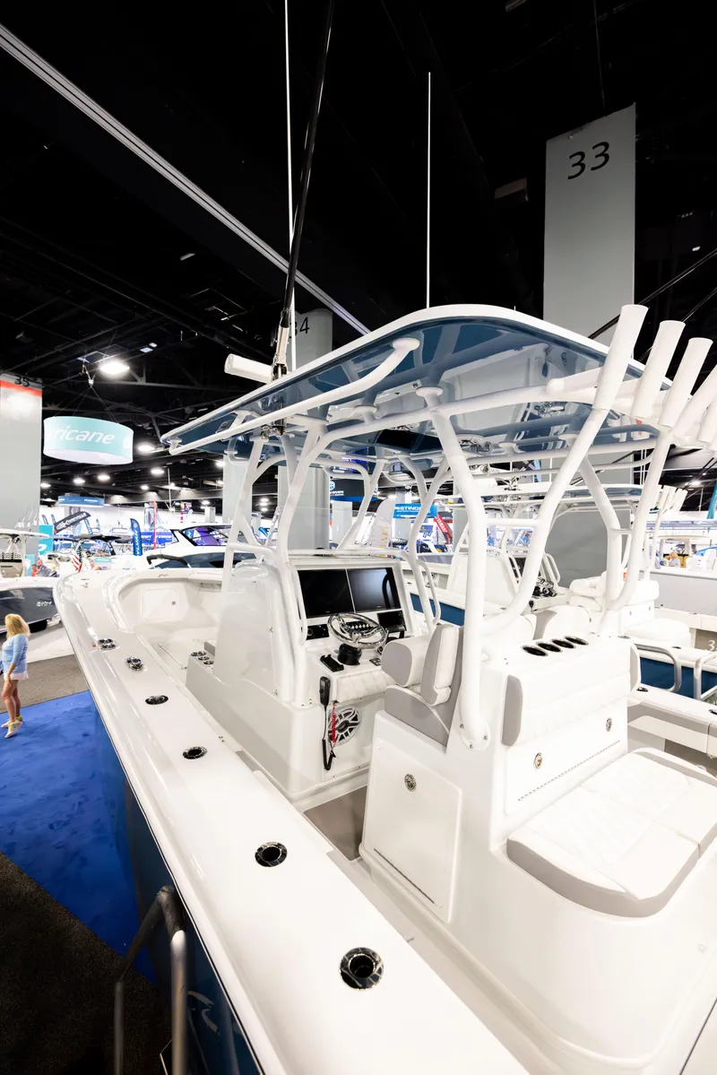 Slide: The Image of 2025 Yellowfin 32 Offshore boat displayed at an indoor exhibition, showcasing sleek design and advanced features. - 3