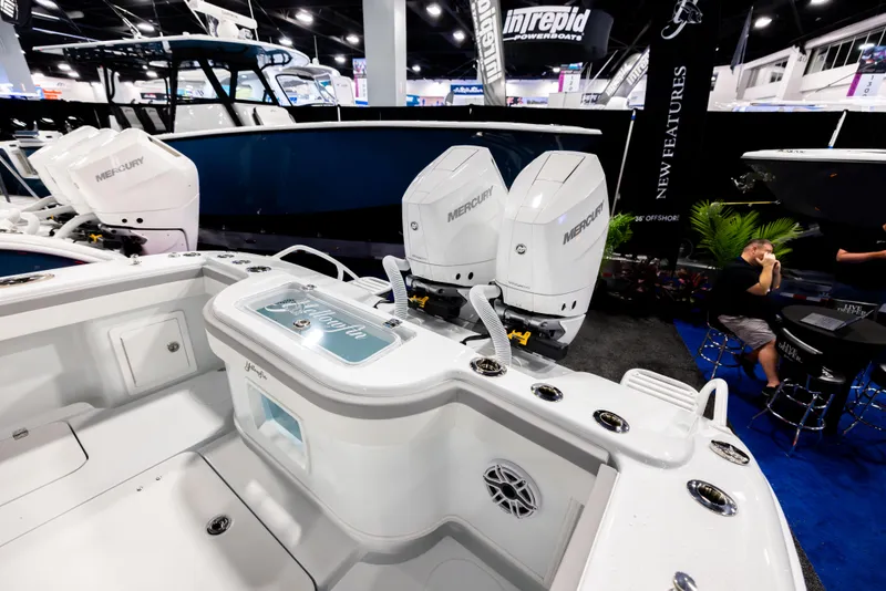 Slide: The Image of 2025 Yellowfin 32 Offshore boat with Mercury engines displayed at a boat show. - 4
