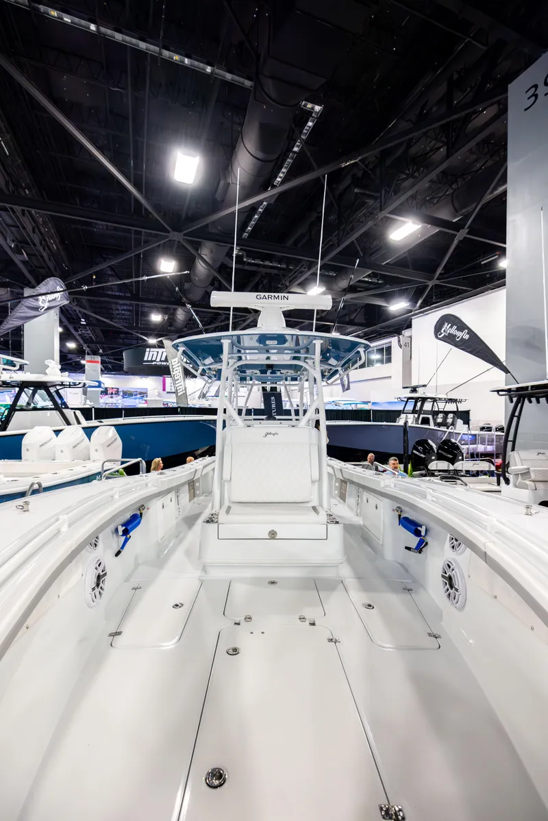 Slide: The Image of 2025 Yellowfin 32 Offshore boat interior at a boat show, showcasing sleek design and spacious layout. - 7