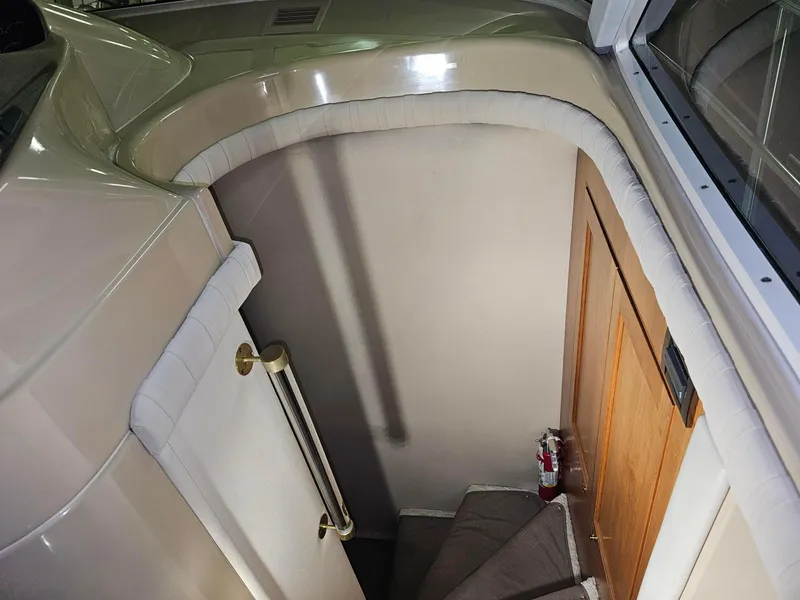 Slide: The Image of 2001 Cruisers Yachts 5000 Sedan Sport interior stairway with wooden door and fire extinguisher. - 14
