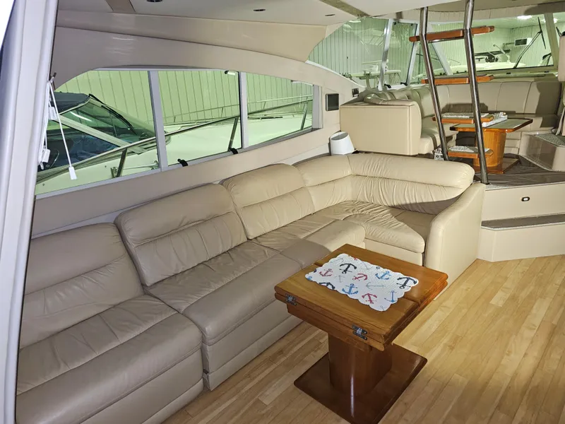 Slide: The Image of Luxurious interior of 2001 Cruisers Yachts 5000 Sedan Sport with beige leather seating. - 17