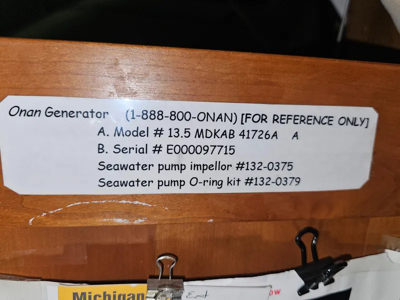 Slide: The Image of Sticker with Onan generator details, including model, serial number, and seawater pump parts. - 27