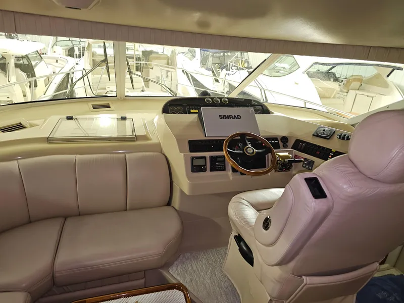 Slide: The Image of 2001 Cruisers Yachts 5000 Sedan Sport interior with leather seating and modern navigation equipment. - 30