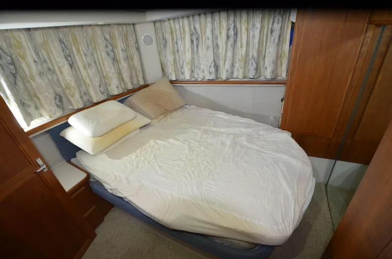 Slide: The Image of Cozy bedroom in 1993 Carver 350 Aft yacht with double bed and wooden accents. - 11