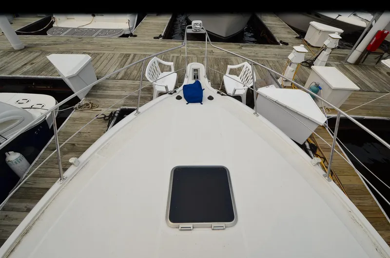 Slide: The Image of 1993 Carver 350 Aft yacht docked, featuring spacious deck and seating area. - 16