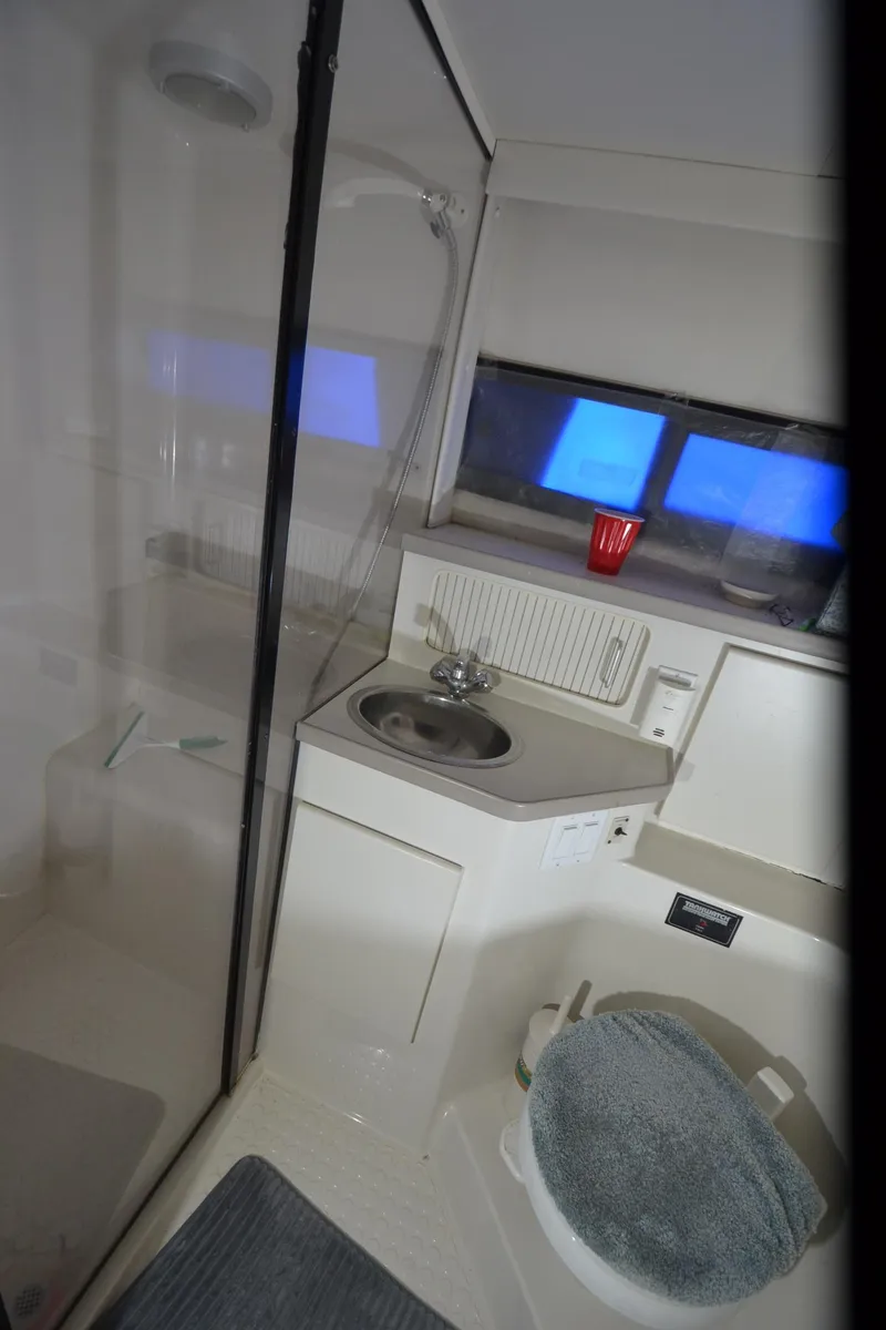 Slide: The Image of 1993 Carver 350 Aft cabin bathroom with shower, sink, and window. - 17