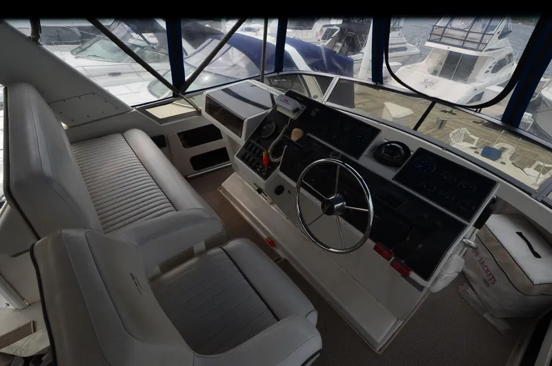 Slide: The Image of 1993 Carver 350 Aft yacht helm with steering wheel and control panel. - 20
