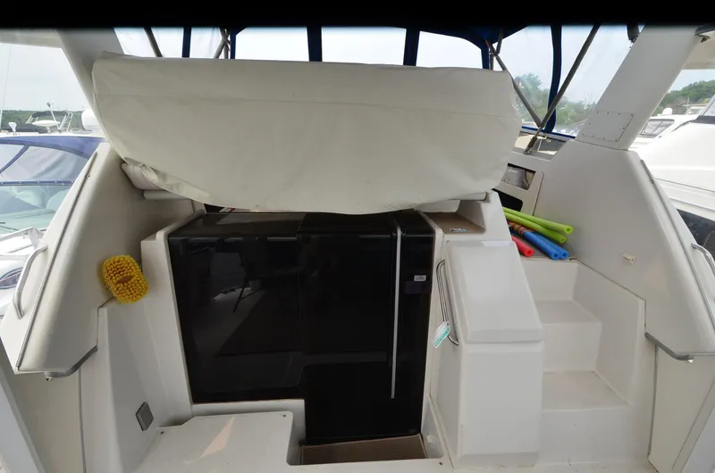Slide: The Image of 1993 Carver 350 Aft yacht interior with covered seating and compact fridge. - 24