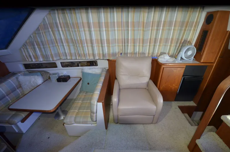 Slide: The Image of Interior of 1993 Carver 350 Aft yacht with seating, table, and cabinetry. - 3