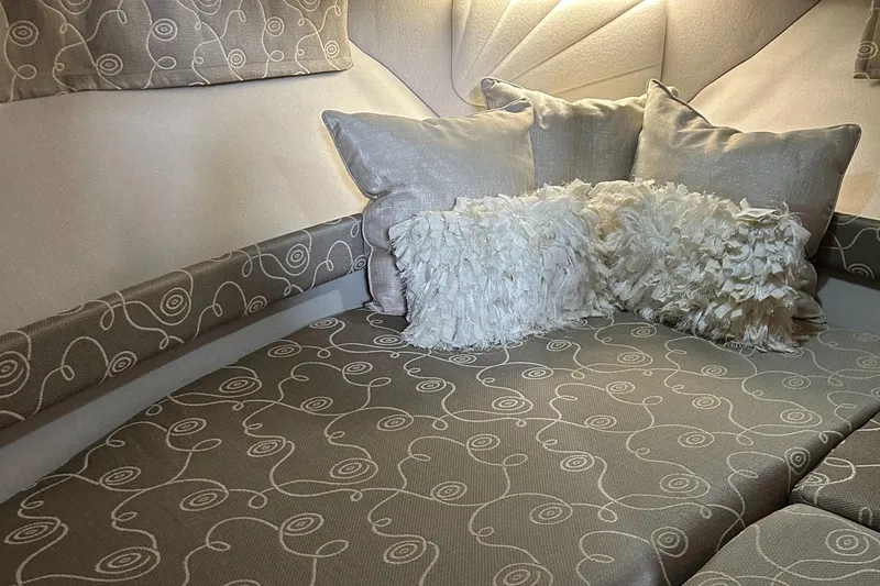 Slide: The Image of 1993 Carver 350 Aft cabin interior with patterned upholstery and decorative pillows. - 8