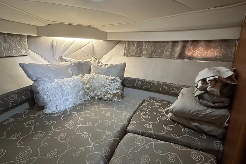 Slide: The Image of 1993 Carver 350 Aft cabin interior with plush bedding and decorative pillows. - 9