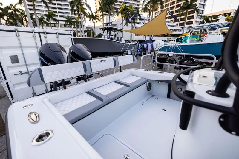 Slide: The Image of 2025 Yellowfin 26 Hybrid boat interior with dual engines, docked at a marina. - 7