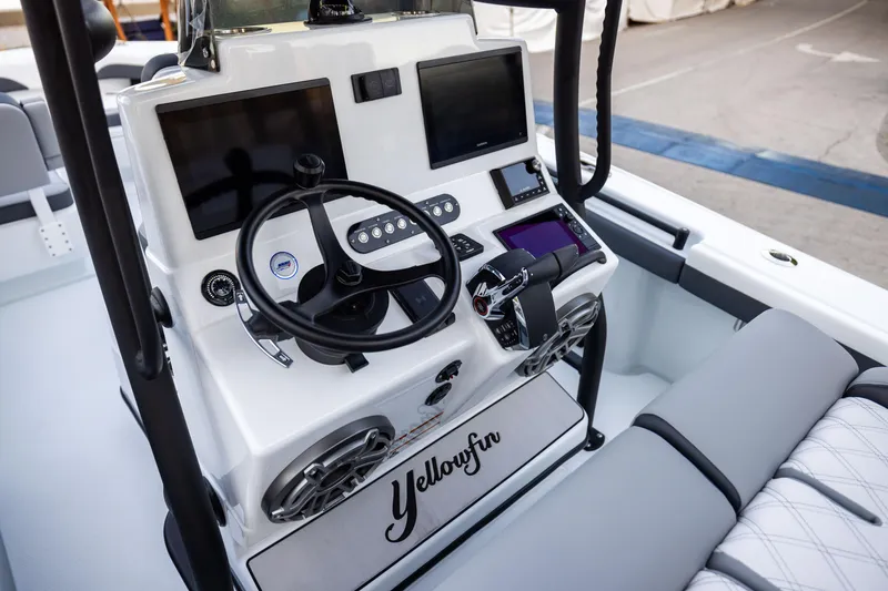 Slide: The Image of 2025 Yellowfin 26 Hybrid boat dashboard with advanced navigation screens and controls. - 8