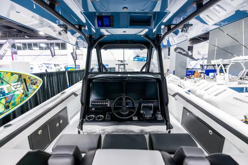 Slide: The Image of 2025 Yellowfin 39 Offshore boat interior with modern helm and controls at a boat show. - 10