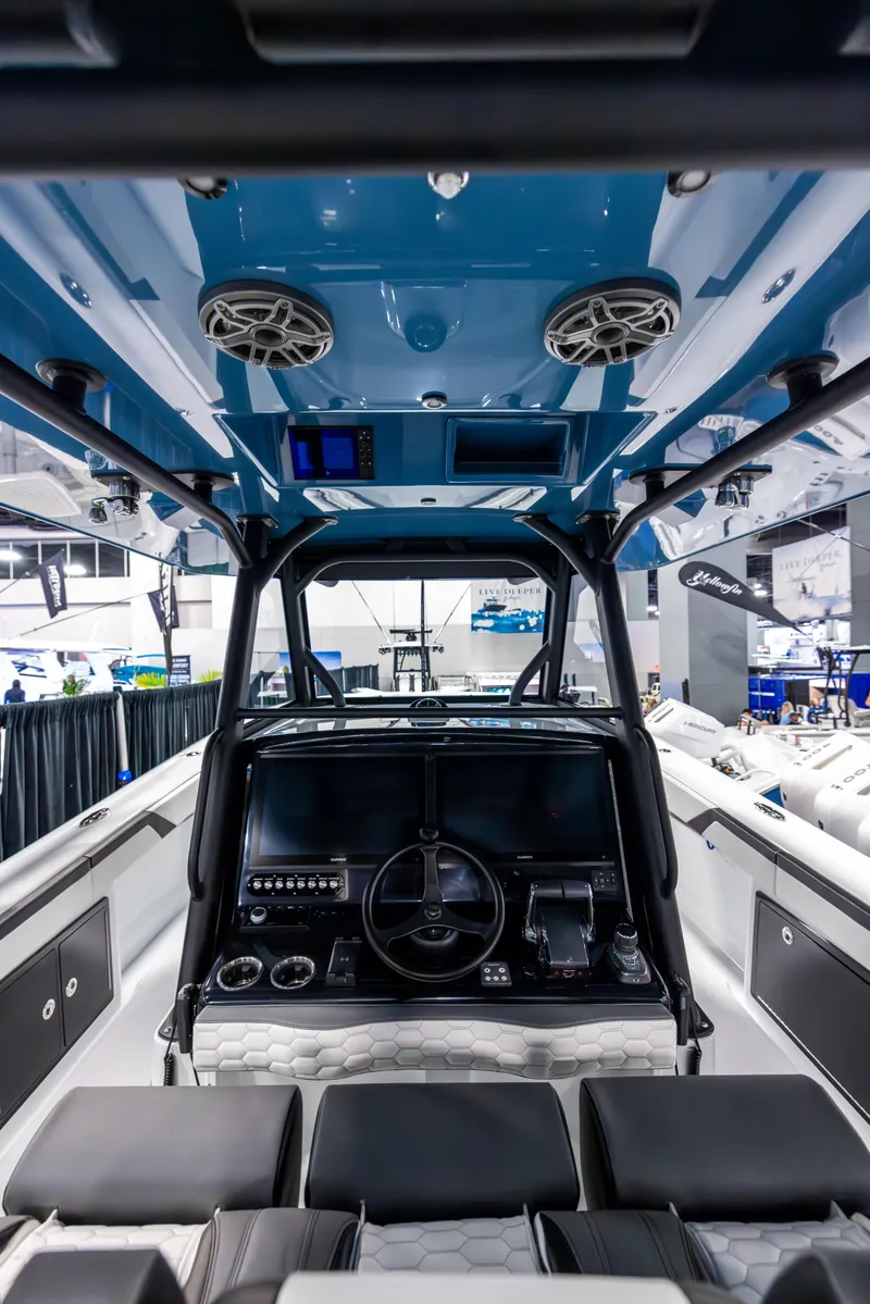 Slide: The Image of 2025 Yellowfin 39 Offshore boat interior with modern dashboard and seating. - 12