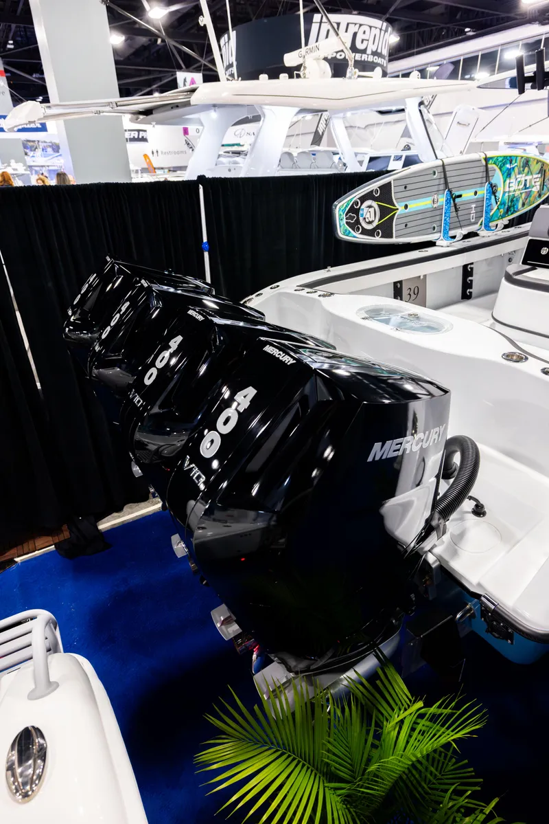 Slide: The Image of 2025 Yellowfin 39 Offshore boat with triple Mercury outboard engines at a boat show. - 2