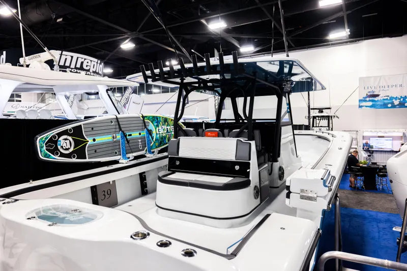 Slide: The Image of 2025 Yellowfin 39 Offshore boat displayed at an indoor exhibition, featuring sleek design and modern amenities. - 3