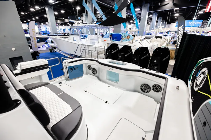 Slide: The Image of 2025 Yellowfin 39 Offshore boat interior at a boat show, showcasing seating and equipment. - 9