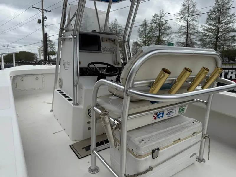Slide: The Image of 2005 Twin Vee 26 Center Console boat interior with helm and rod holders. - 12