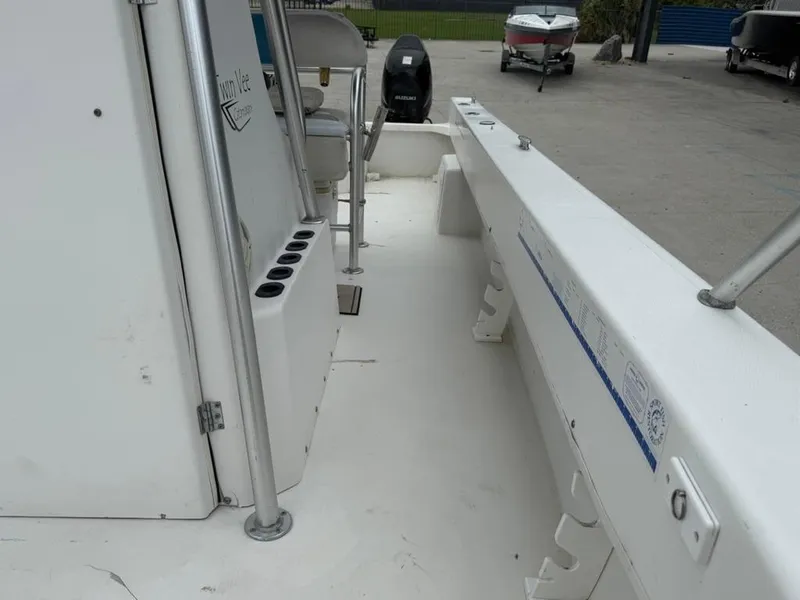 Slide: The Image of 2005 Twin Vee 26 Center Console boat interior with seating and rod holders. - 15