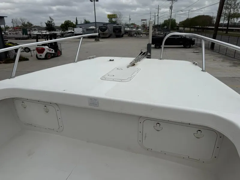 Slide: The Image of 2005 Twin Vee 26 Center Console boat, white deck, parked outdoors, cloudy sky. - 8