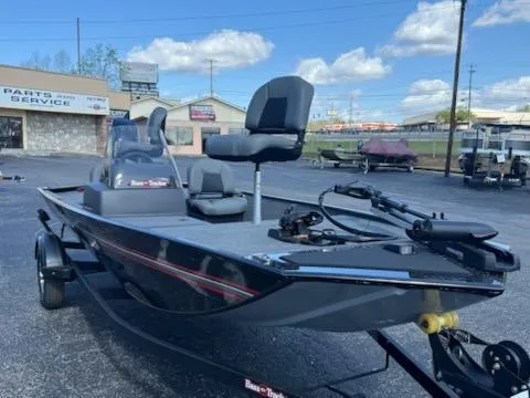 Slide: The Image of 2025 Tracker Bass Tracker Classic XL boat in a parking lot under a blue sky. - 2