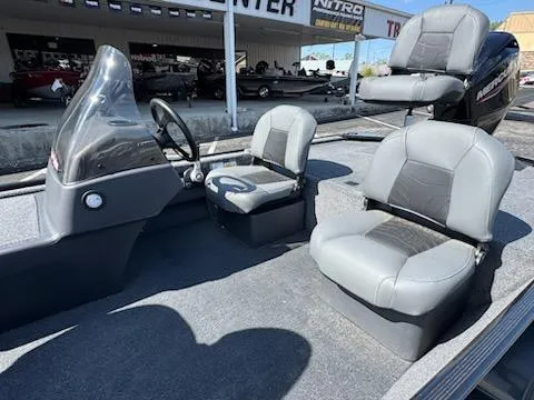 Slide: The Image of 2025 Tracker Bass Tracker Classic XL interior with gray seating and steering console. - 6