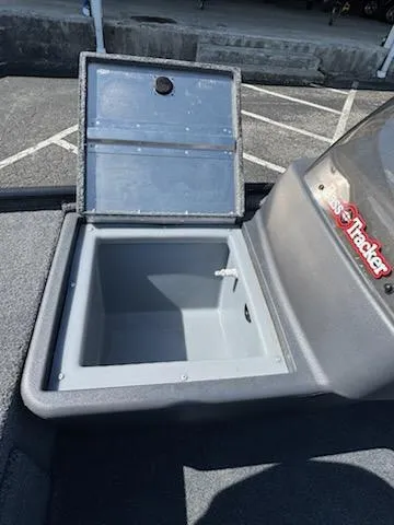 Slide: The Image of 2025 Tracker Bass Tracker Classic XL livewell, open lid, gray interior, parked on asphalt. - 8