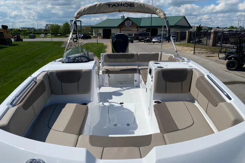 Slide: The Image of 2025 Tahoe 2150 boat with spacious seating and modern design, docked outdoors. - 3