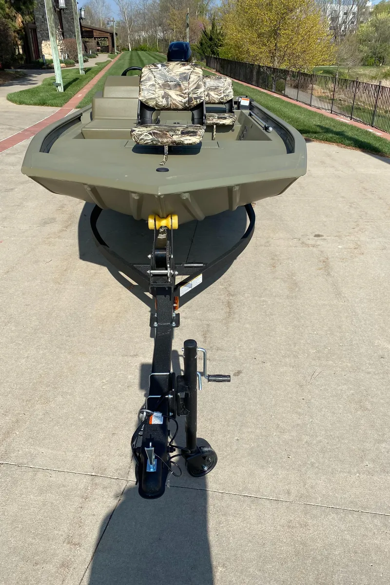 Slide: The Image of 2025 Tracker Grizzly 1754 SC boat on trailer, parked on concrete surface. - 2