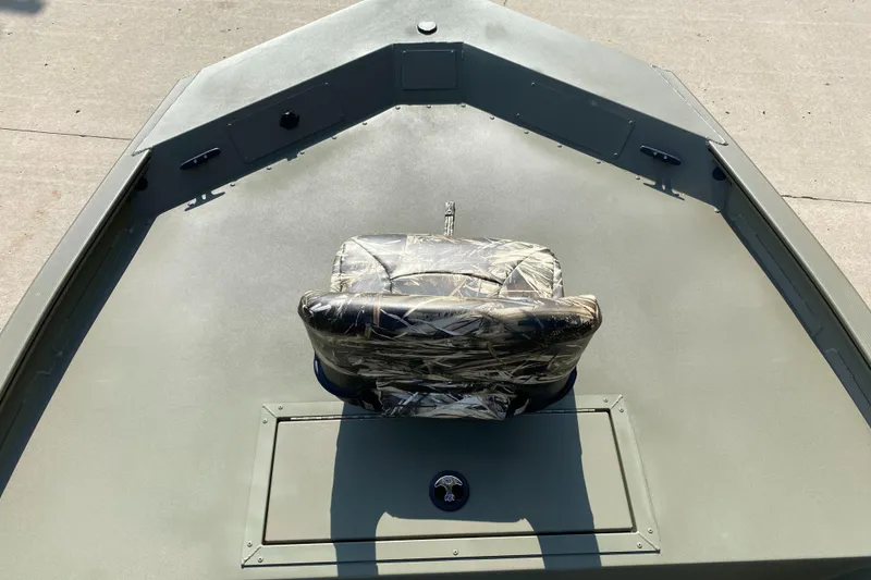 Slide: The Image of 2025 Tracker Grizzly 1754 SC boat interior with camo seat, viewed from above. - 3