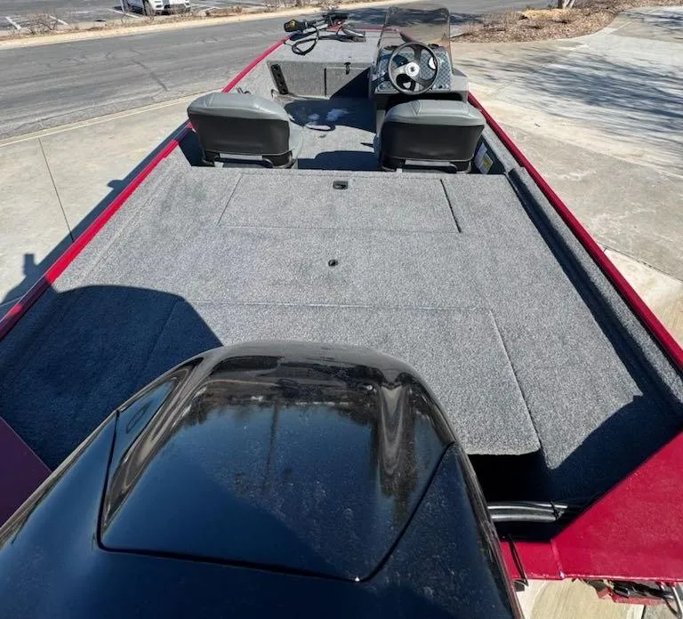 Slide: The Image of 2025 Tracker Bass Tracker Classic XL boat interior with seating and steering console. - 2