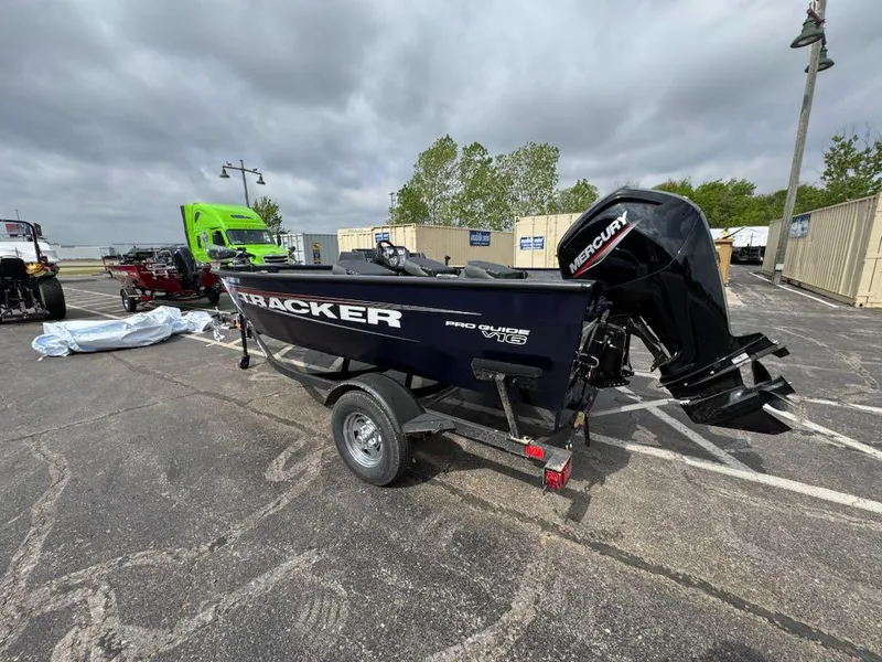 Slide: The Image of 2025 Tracker Pro Team 190 boat with Mercury engine on trailer in parking lot. - 2