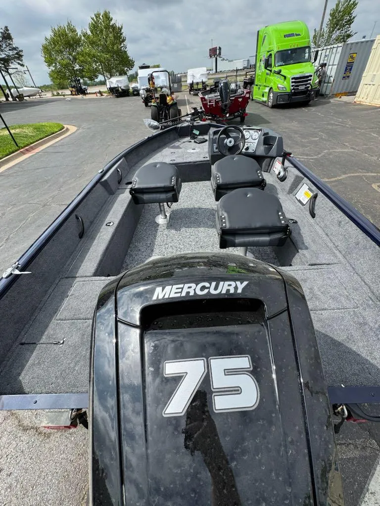 Slide: The Image of 2025 Tracker Pro Team 190 boat with Mercury 75 engine, parked outdoors. - 6