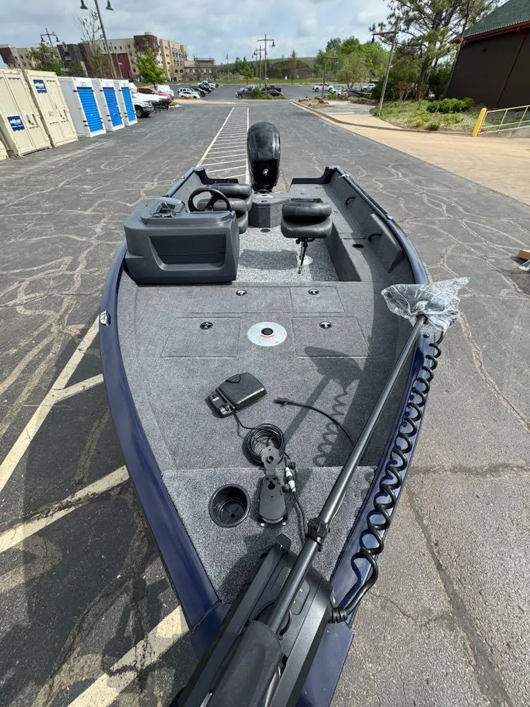 Slide: The Image of 2025 Tracker Pro Team 190 boat, spacious deck, modern design, parked outdoors. - 7