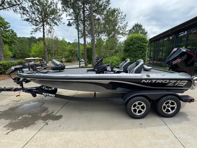 Slide: The Image of 2025 Nitro Z19 Pro boat on trailer, parked outdoors with trees in background. - 0