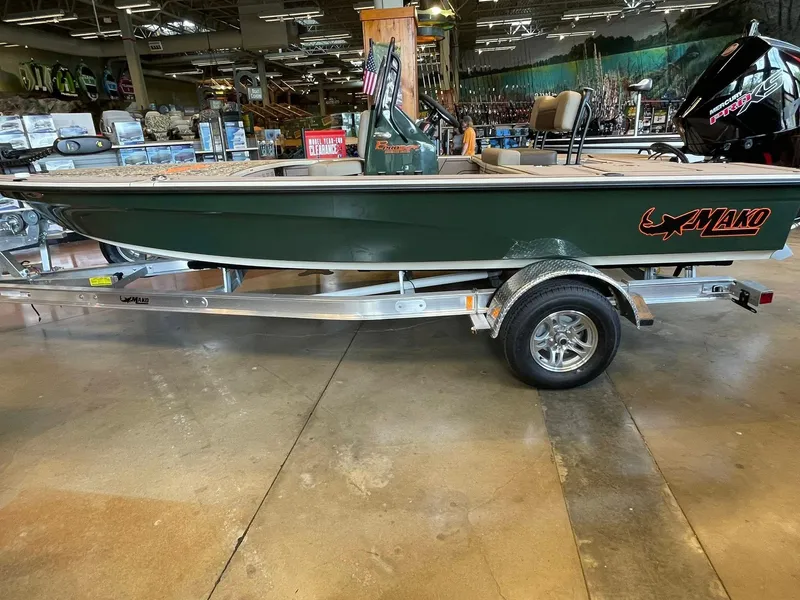 The Image of 2025 Mako 18 Pro Skiff Backwater Edition boat on display in a showroom. - 0