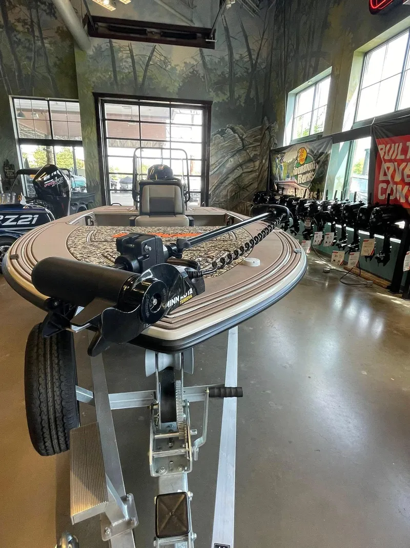 Slide: The Image of 2025 Mako 18 Pro Skiff Backwater Edition displayed in showroom, featuring advanced trolling motor. - 2