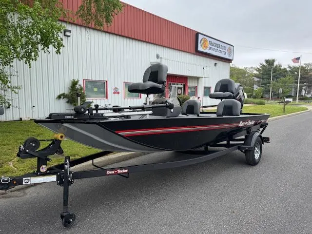 Slide: The Image of 2025 Tracker Bass Tracker Classic XL boat on trailer outside service center. - 3