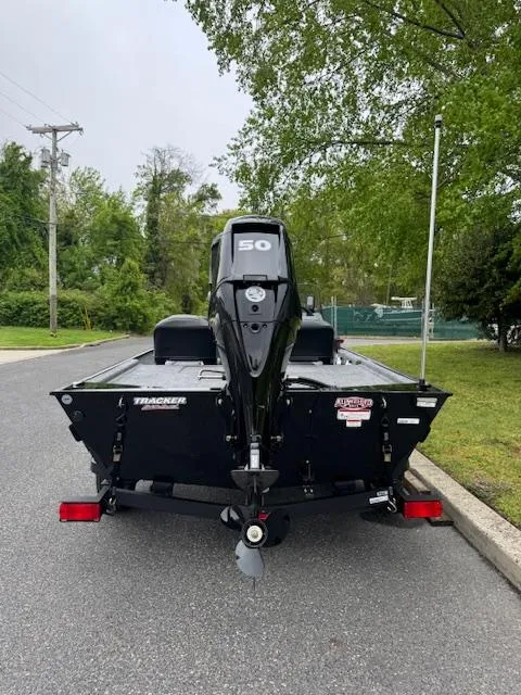 Slide: The Image of 2025 Tracker Bass Tracker Classic XL boat, rear view, parked on a street. - 4