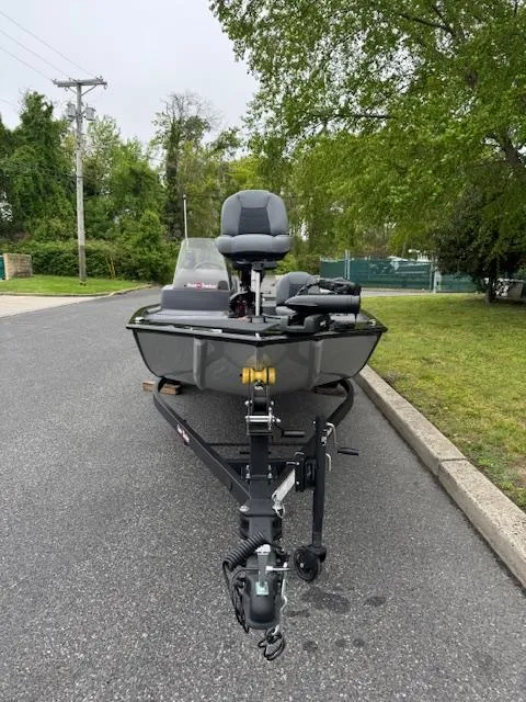 Slide: The Image of 2025 Tracker Bass Tracker Classic XL boat on trailer, parked on a suburban street. - 5
