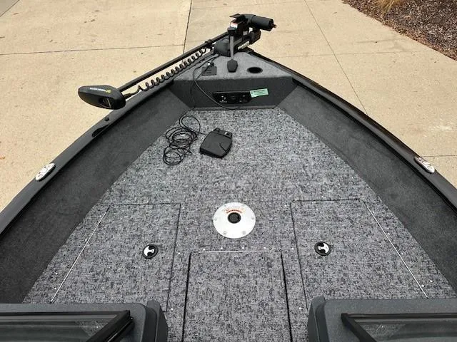 Slide: The Image of 2025 Tracker Pro Guide V-175 WT boat deck with trolling motor and carpeted surface. - 4