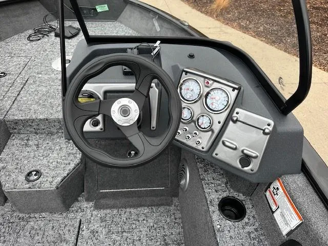 Slide: The Image of 2025 Tracker Pro Guide V-175 WT boat dashboard with steering wheel and instrument panel. - 6